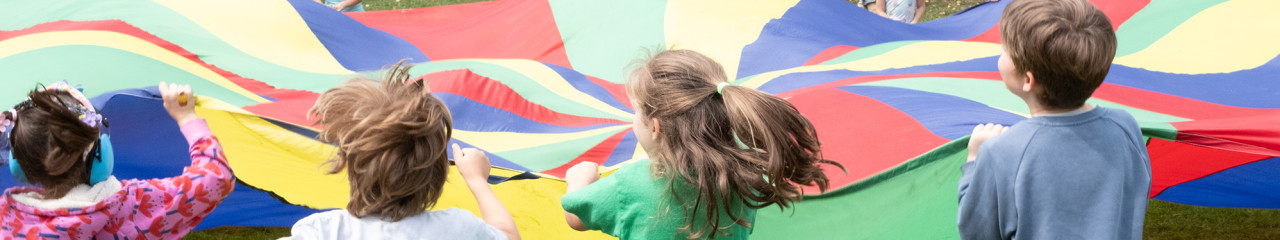 children holding parachute outdoors in Grange Park