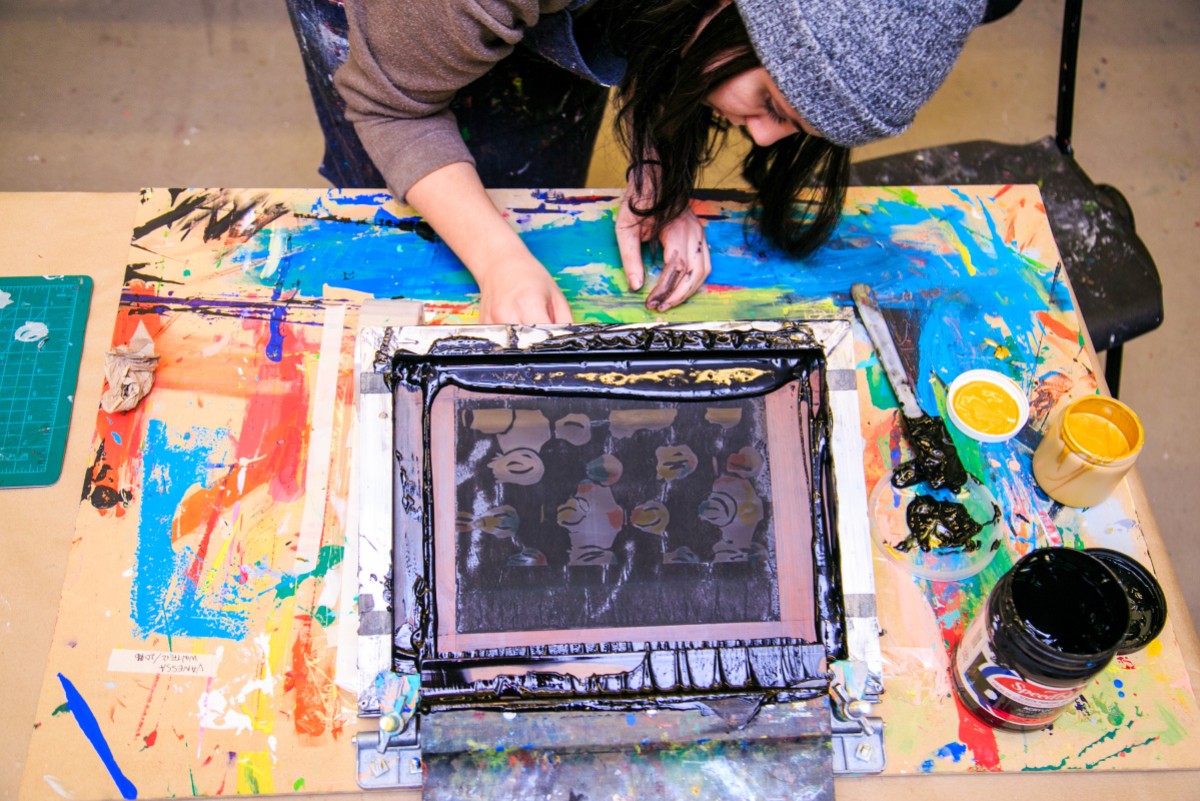 youth at printmaking easel