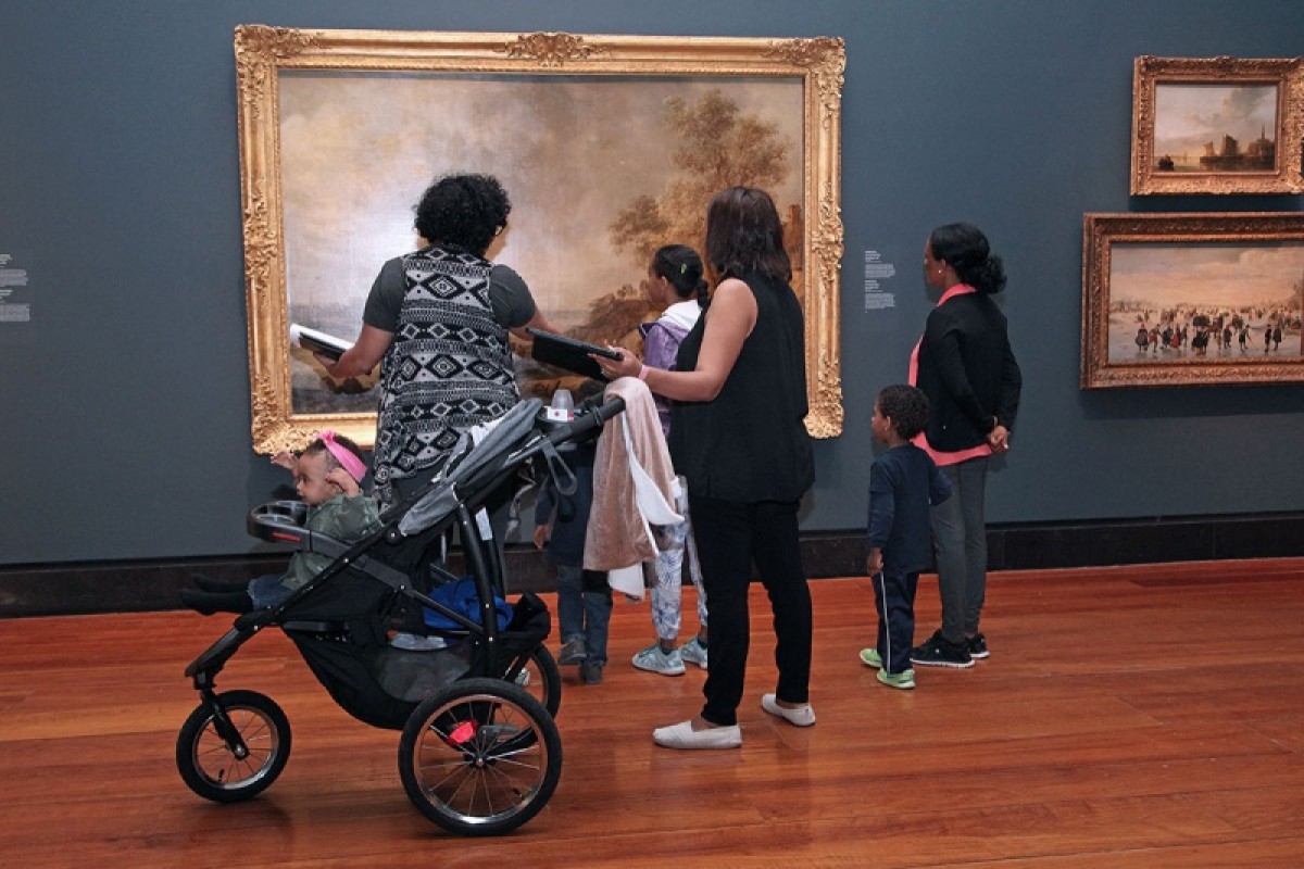 Caregivers and children in the AGO look at a painting