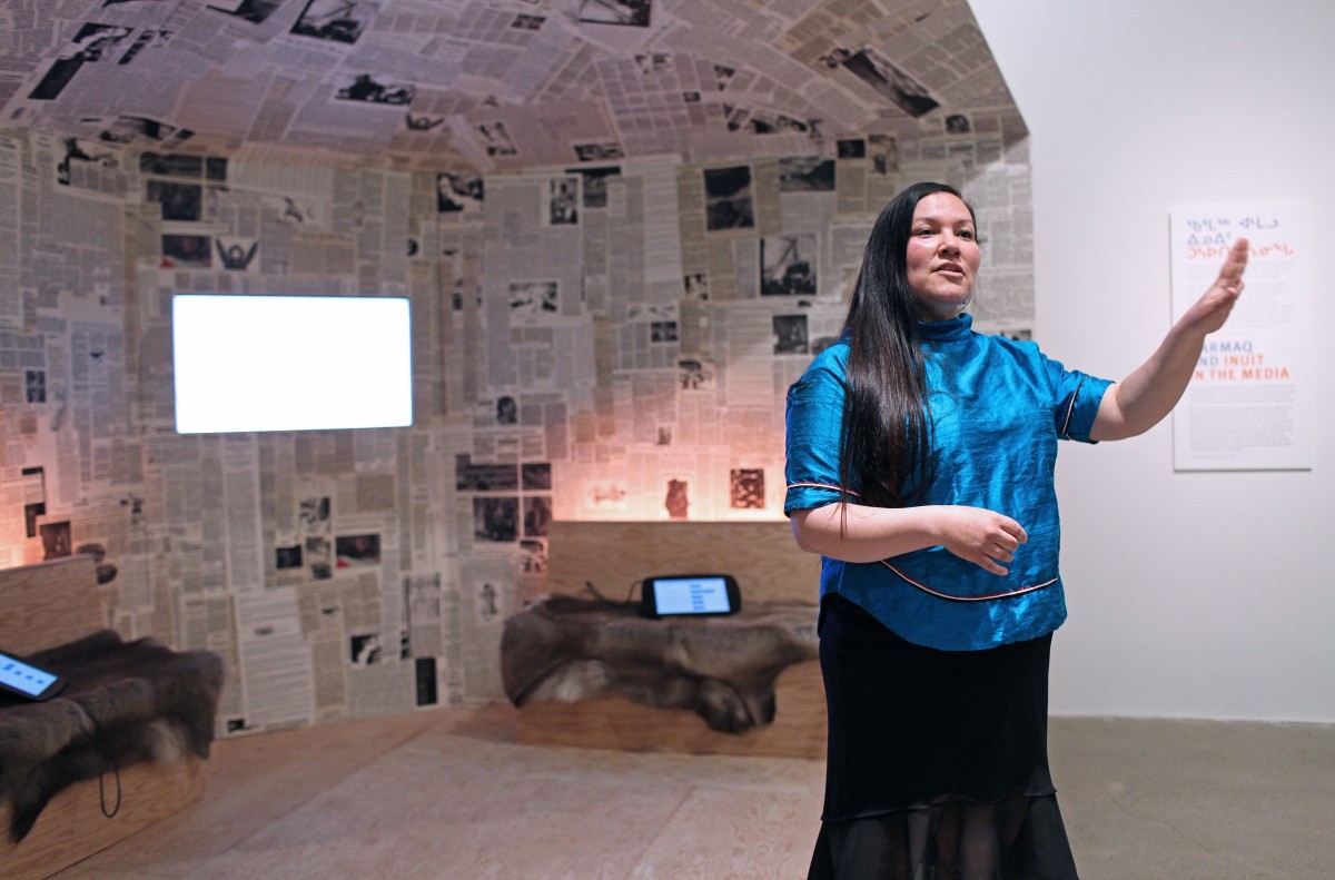 Curator and artist Taqralik Partridge shows archival newsprint in the shape of a traditional Inuit qarmaq