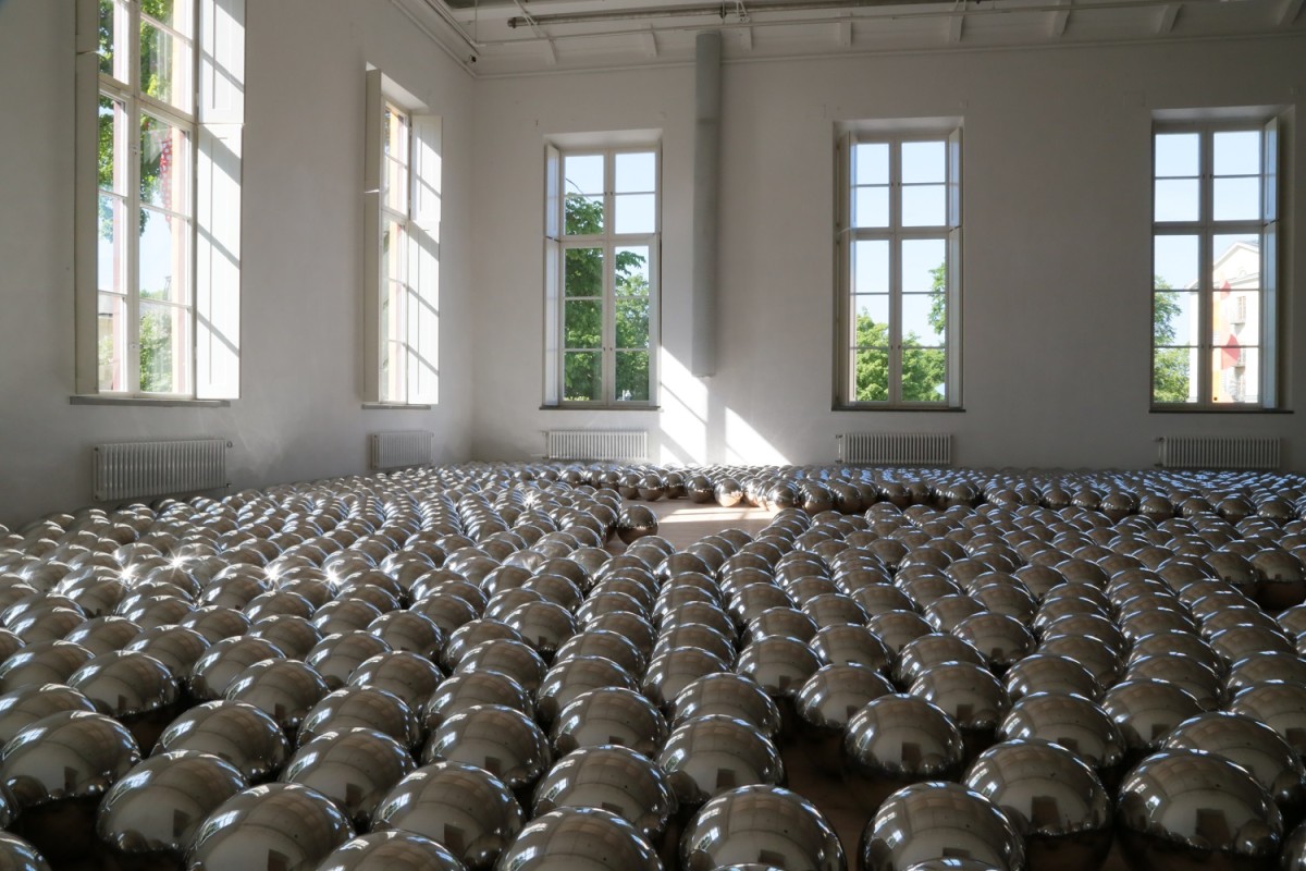 A room full of silver balls on the ground