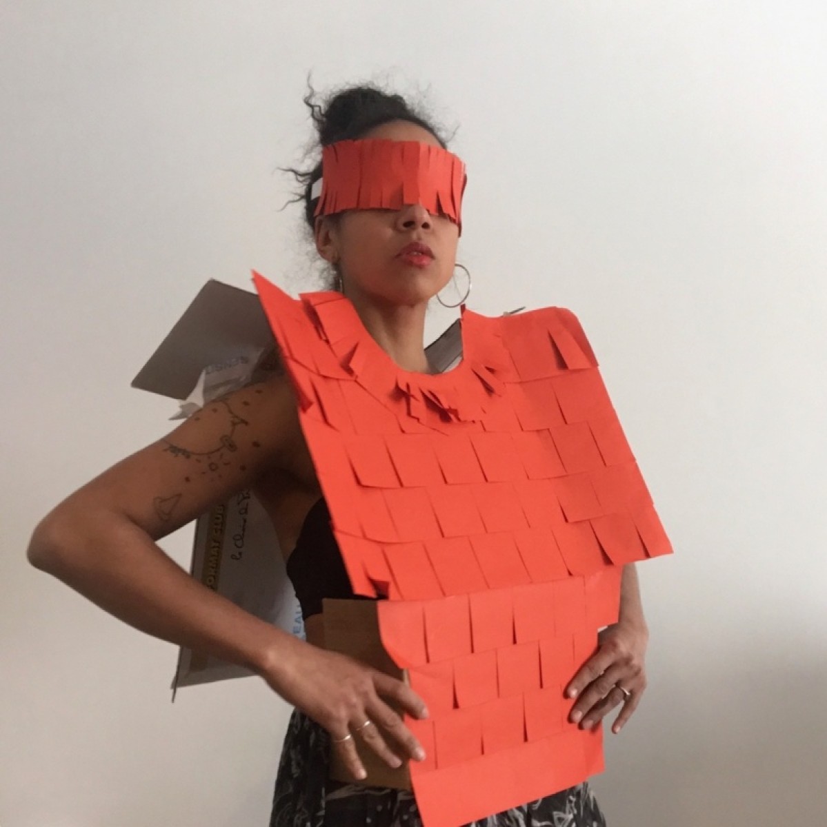 A woman wearing a costume made of orange paper