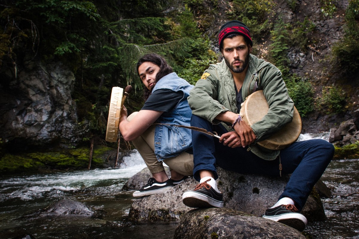 Hip-hop duo Mob Bounce sitting by a stream