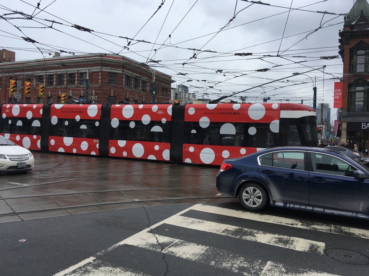 A TTC streetcar covered in red dots