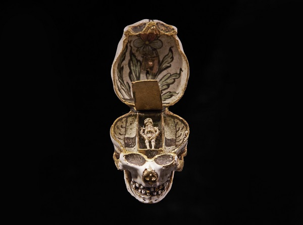 Skeleton laying inside a skull