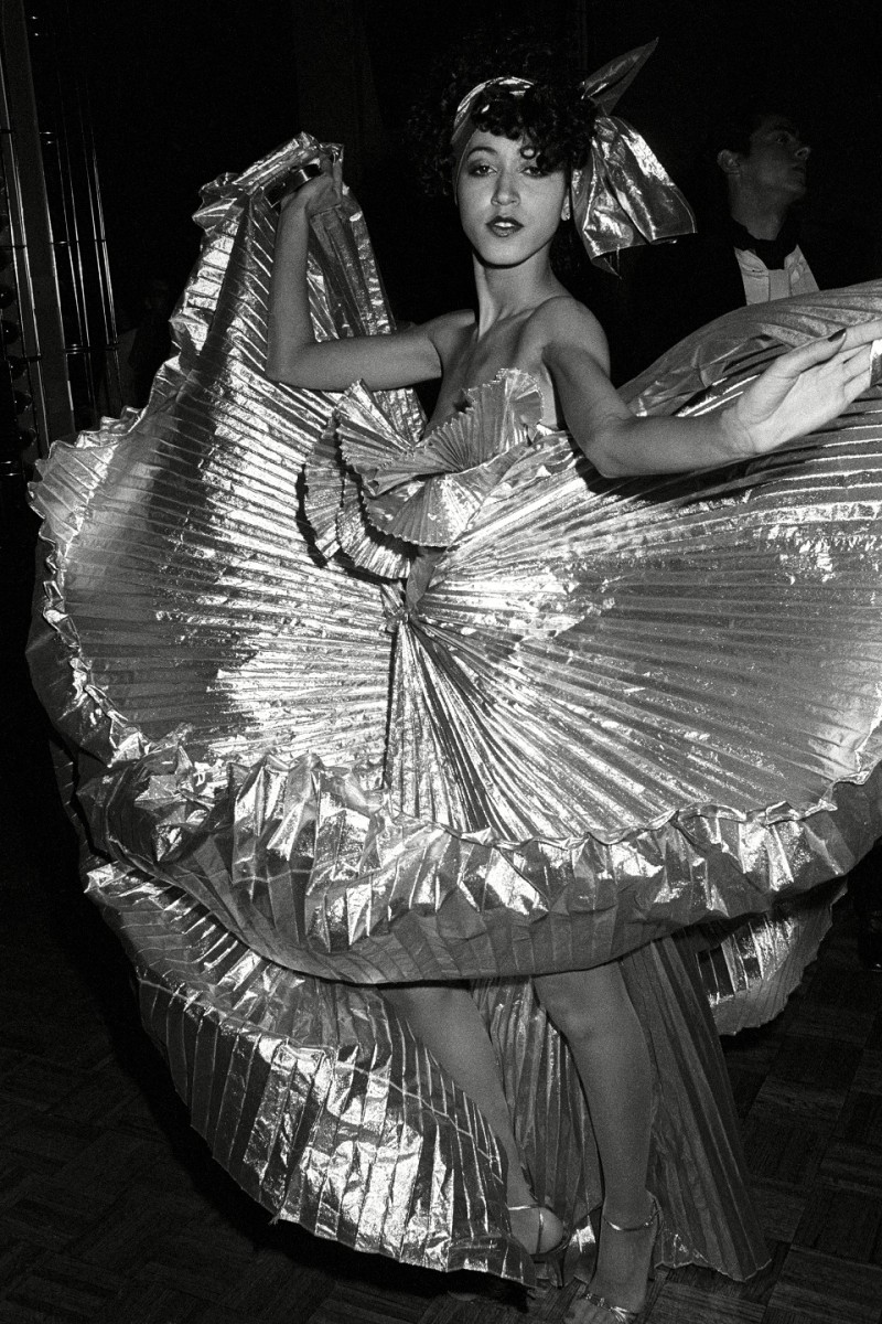 Black and white photo of fashion model Pat Cleveland wearing a silver Halston dress at Studio 54
