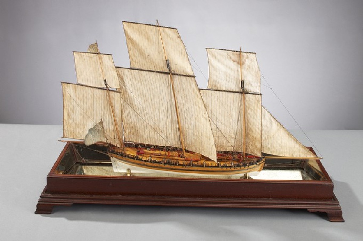 Three masted model ship with large sails 