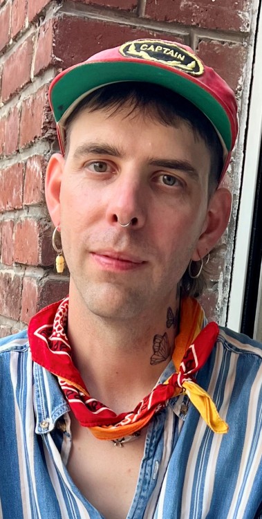 Dan Jamieson wearing cap on head and red bandana around neck