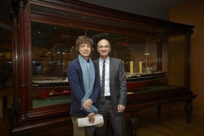 Mick Jagger & Matthew Teitelbaum standing in front of model ship display