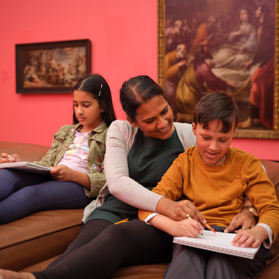 Children sketching in gallery with caregiver