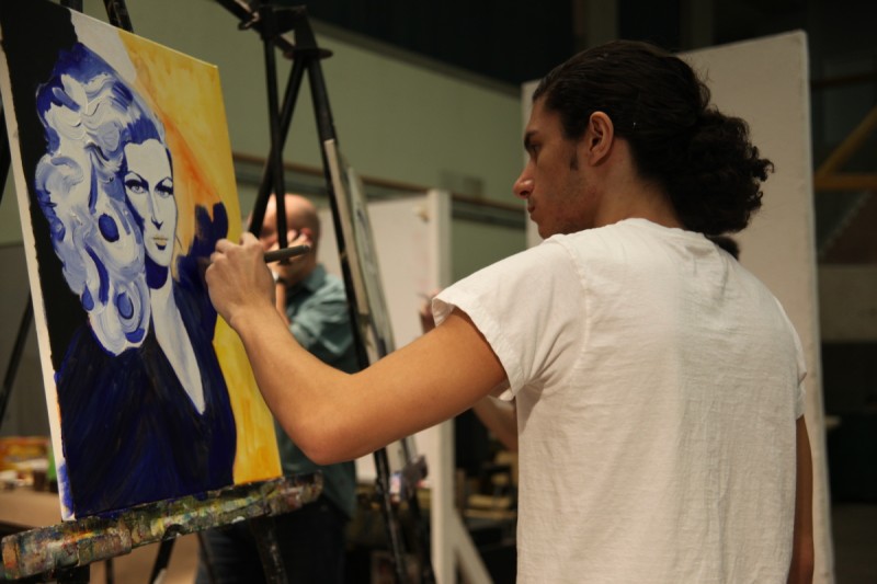 Man painting in gallery school class