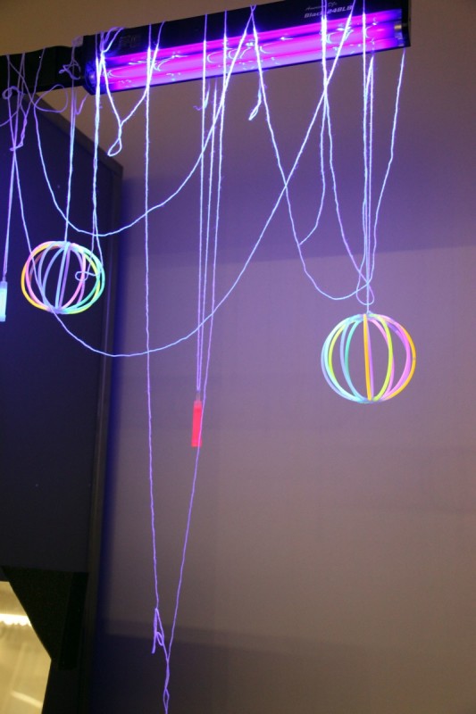 glow stick globes dangling under neon lights