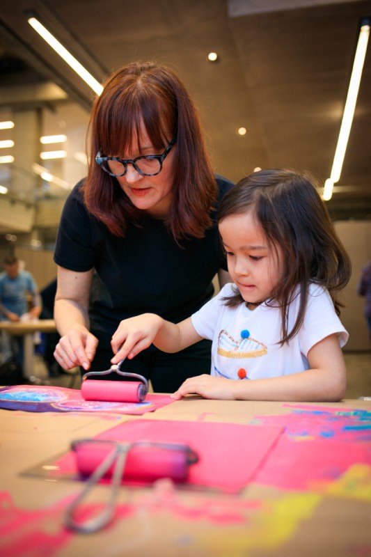 child painting with adult