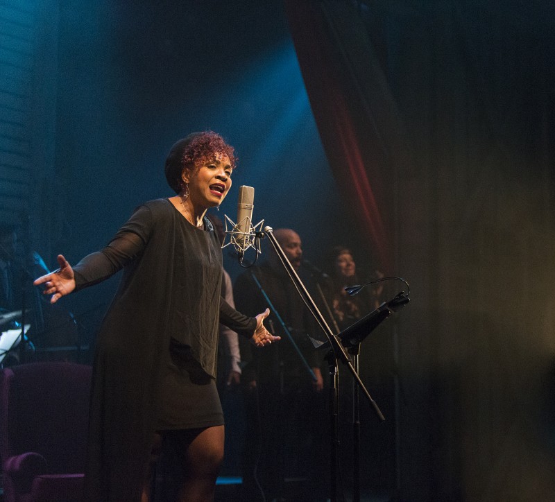 image of Soulpepper performer singing in front of an old-style microphone
