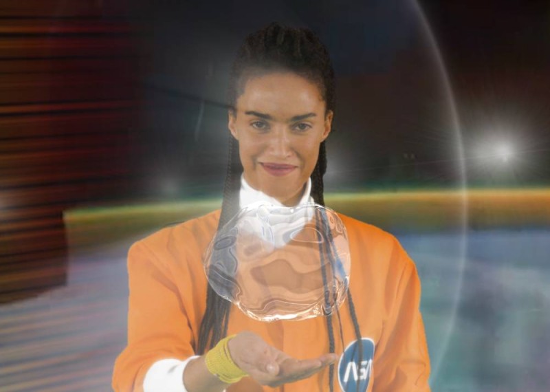 Woman with bubble of water hovering above her open hand.