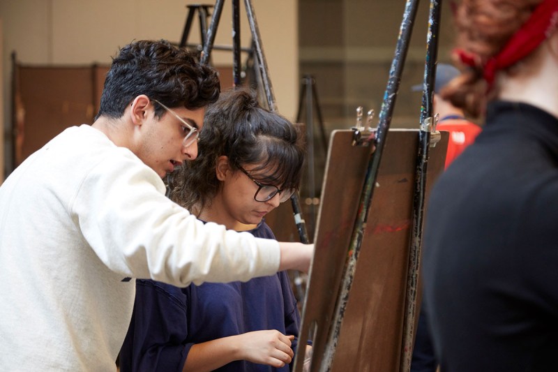 Two people at an easel