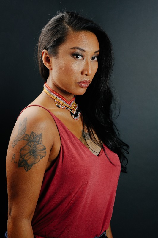 photo of artist Catherine Hernandez in a red top