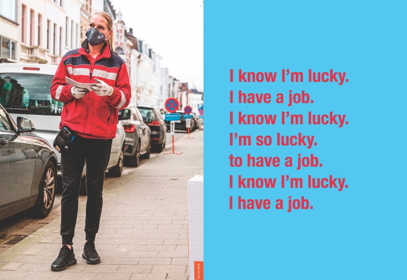 A delivery person stands on a city street.  Block of text on the right: I know I'm lucky. I have a job. I'm so lucky. to have a job. I know I'm lucky. I have a job.