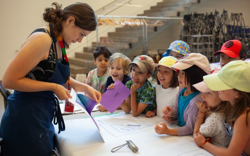 kids watching teacher demo duing AGO art class/camp