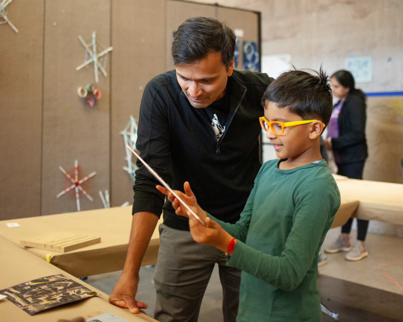 parent and child looking at art