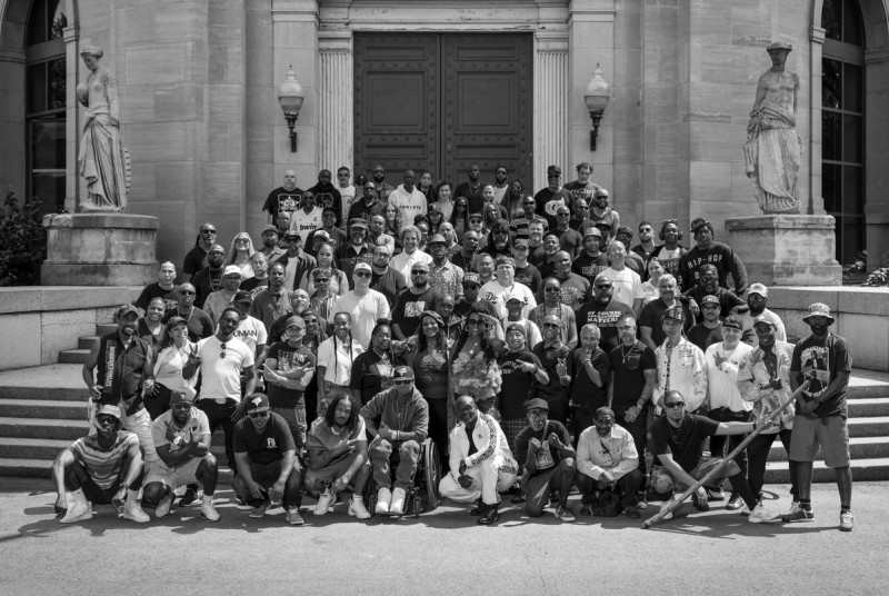 A black and white photo of Hip Hop artists in Toronto, standing on a staircase. 