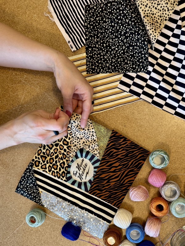 Images of various fabrics, threads, and a pair of hands with a needle, sewing. Neon Needle's logo sits in the centre 