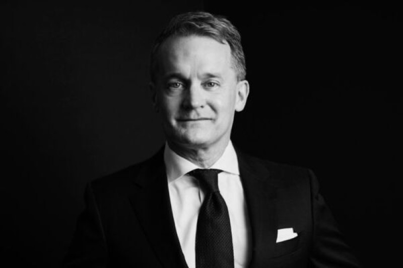 A black and white photo of Seamus O'Regan, wearing a suit, looking directly at the viewer