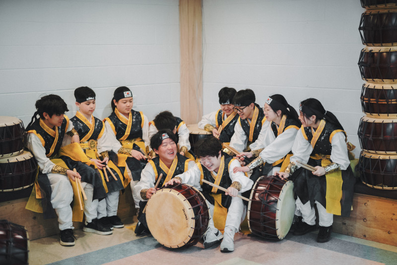 A group of students playing Korean drums 