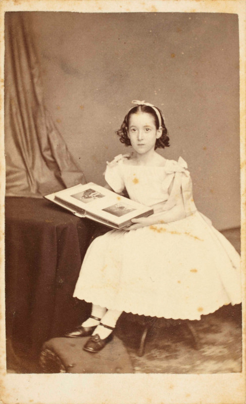 John Harrington Noverre, Unknown Sitter, Portrait of a Seated Girl Posed with a Cabinet Card Album