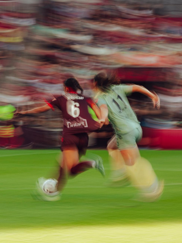 two women playing soccer