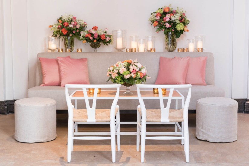 table with sofa and chairs, floral arrangements, candles