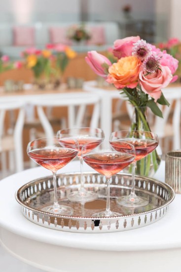 four glasses with rose on silver platter
