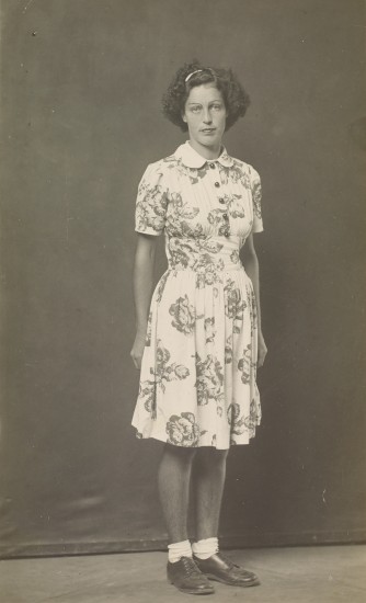 Gelatin silver print of Woman wearing flowered dress, standing