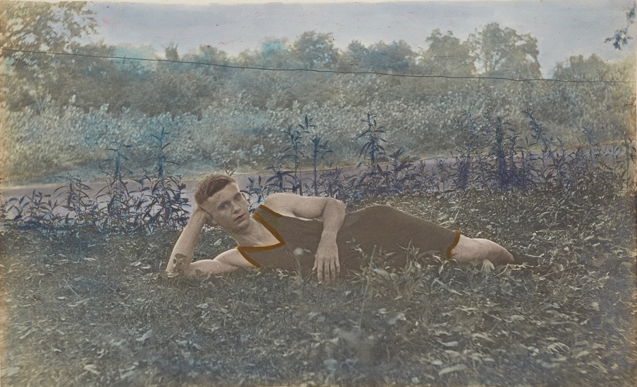 Gelatin silver print with applied colour, A reclining young man wearing a bathing suit