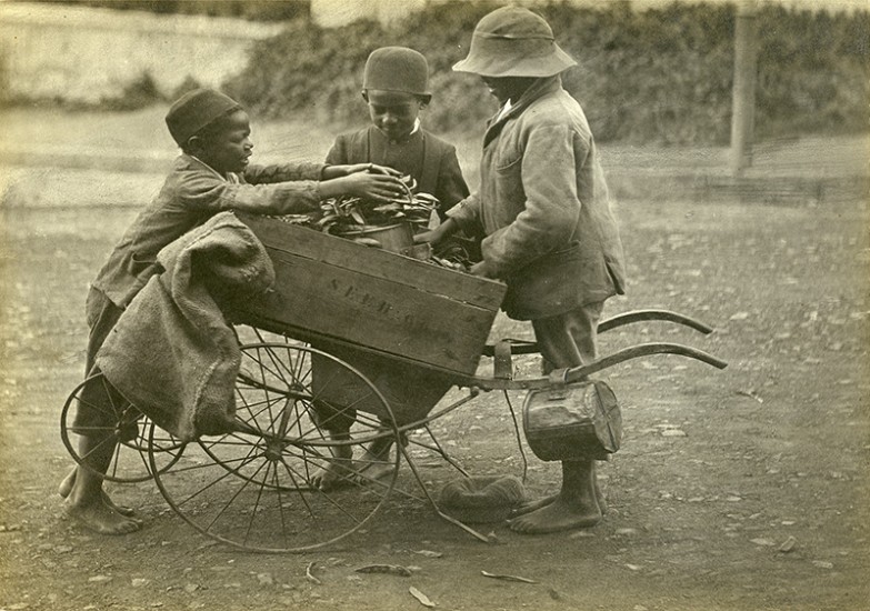 Silver bromide print of children around a wagon