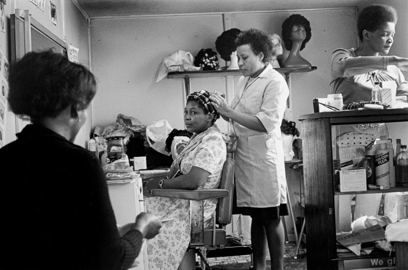 Vanley Burke. Mrs Walker and her customers at her hairdressers shop, Rookery Road, 1979, printed 2023. Gelatin silver print.