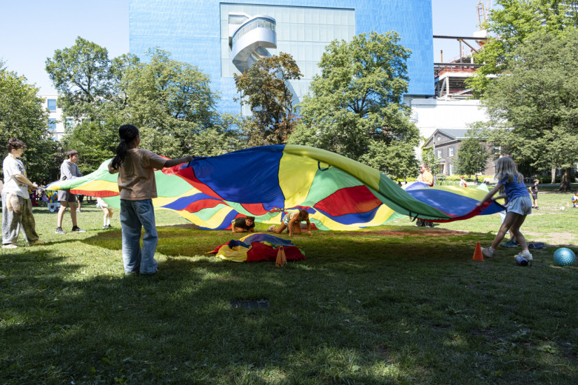 children playing with parachute outdoors in Grange Park